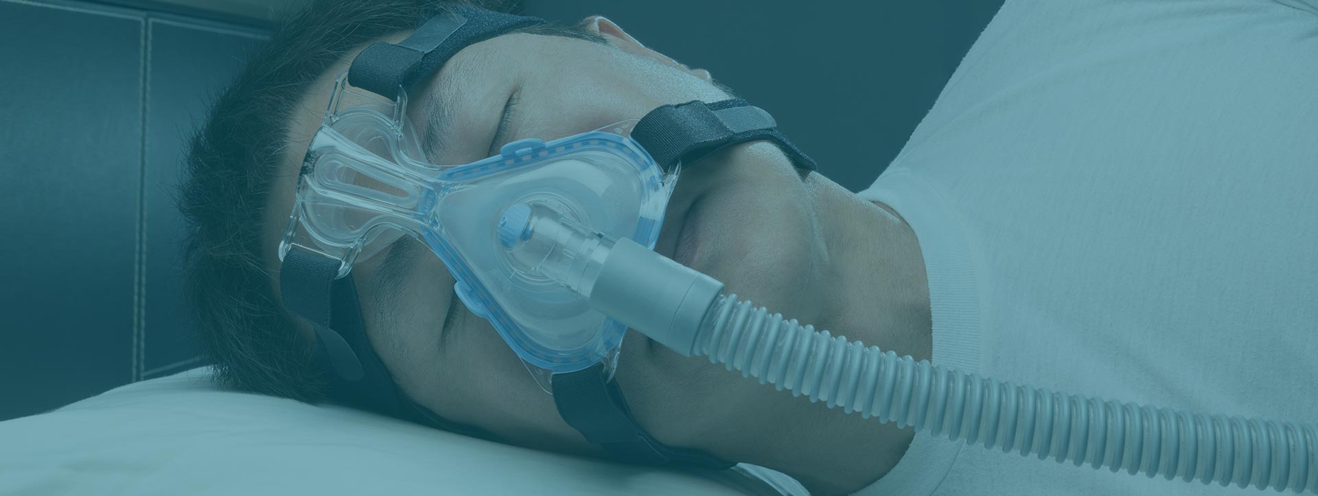 Man sleeping using CPAP machine